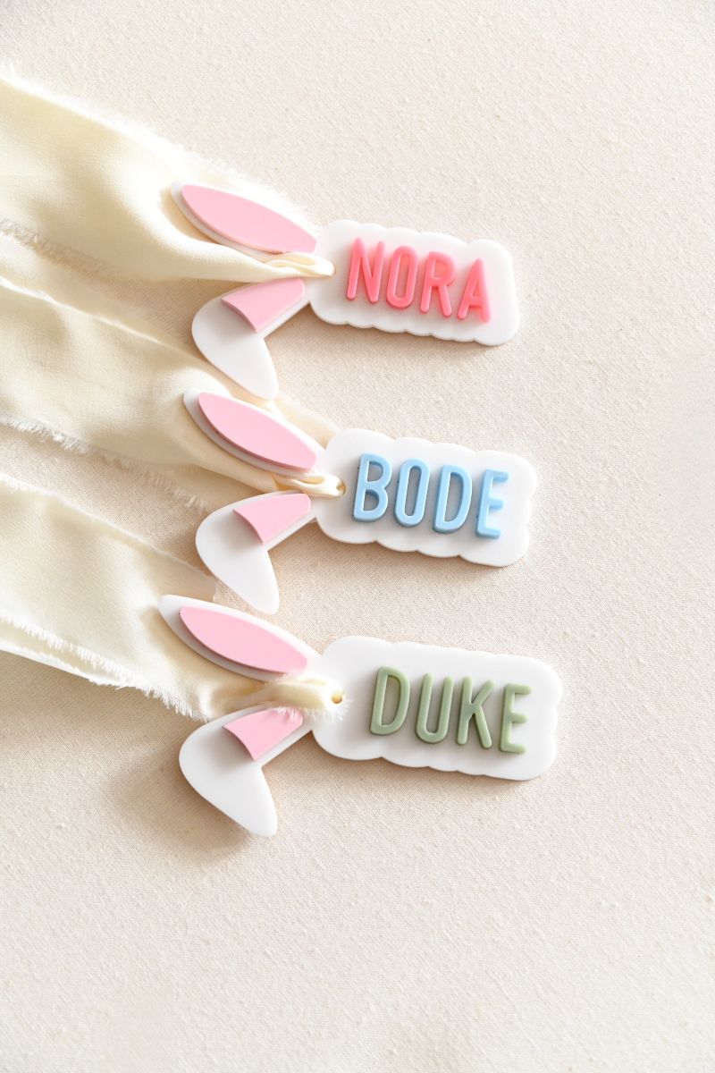 Bunny Ear Name Gift Tag. Custom name in your choice of pink, blue, or green, with soft light pink-filled ears for a sweet and festive look.