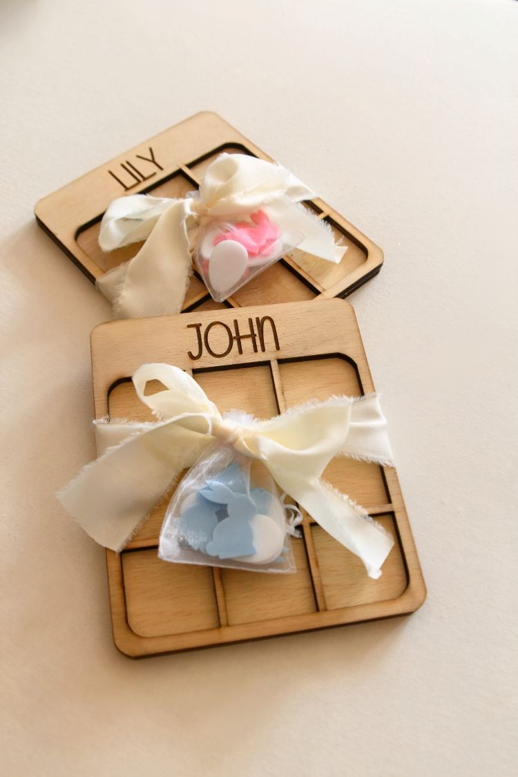 handcrafted tic tac toe set is made from high-quality wood and comes with cute acrylic game pieces—blue or pink bunnies and white eggs as the X’s and O’s.